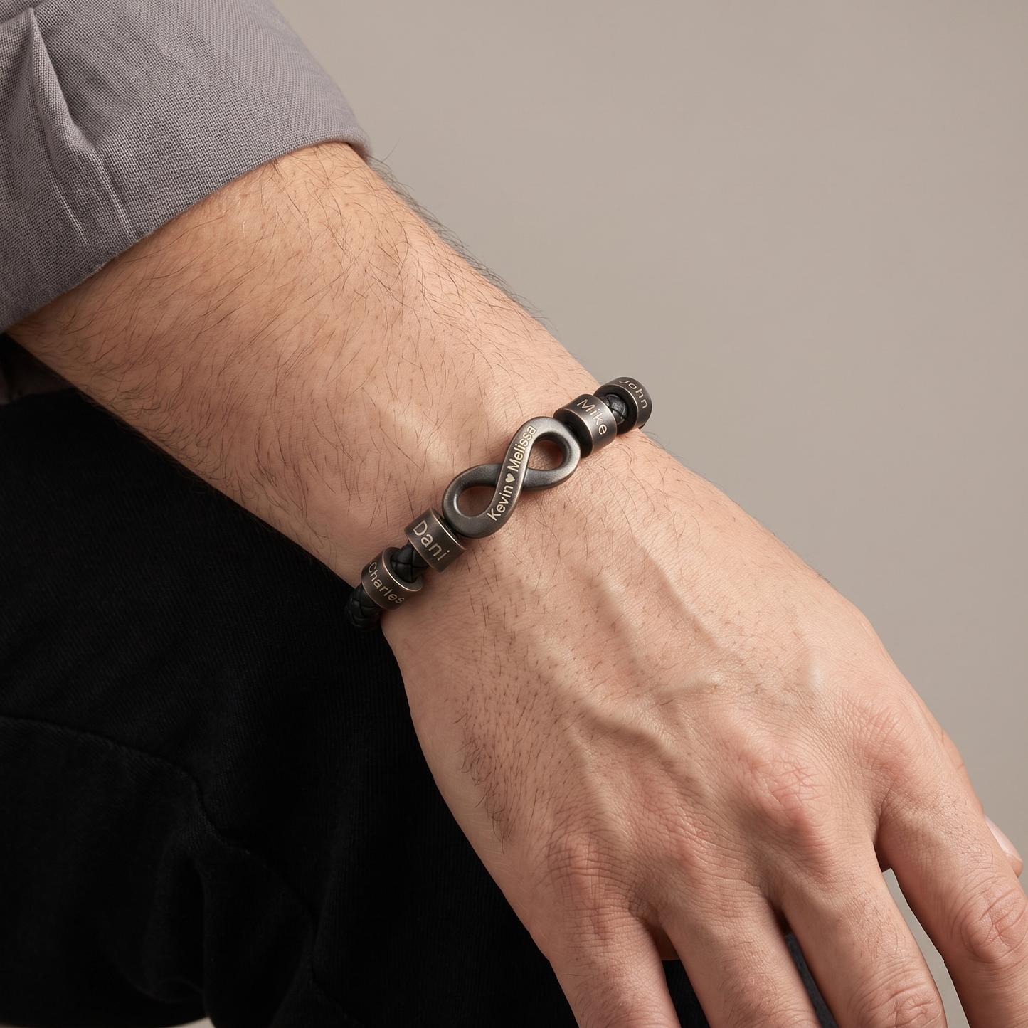 Men's infinity name bracelet worn detail