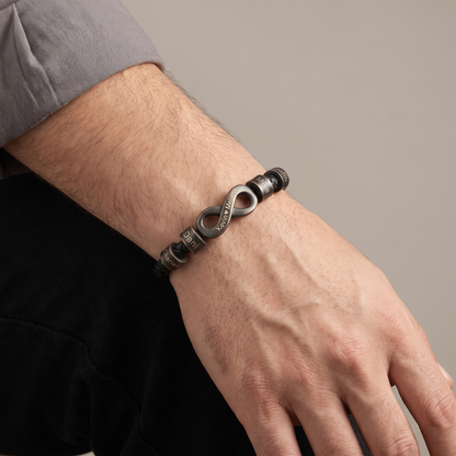 Men's infinity name bracelet worn detail