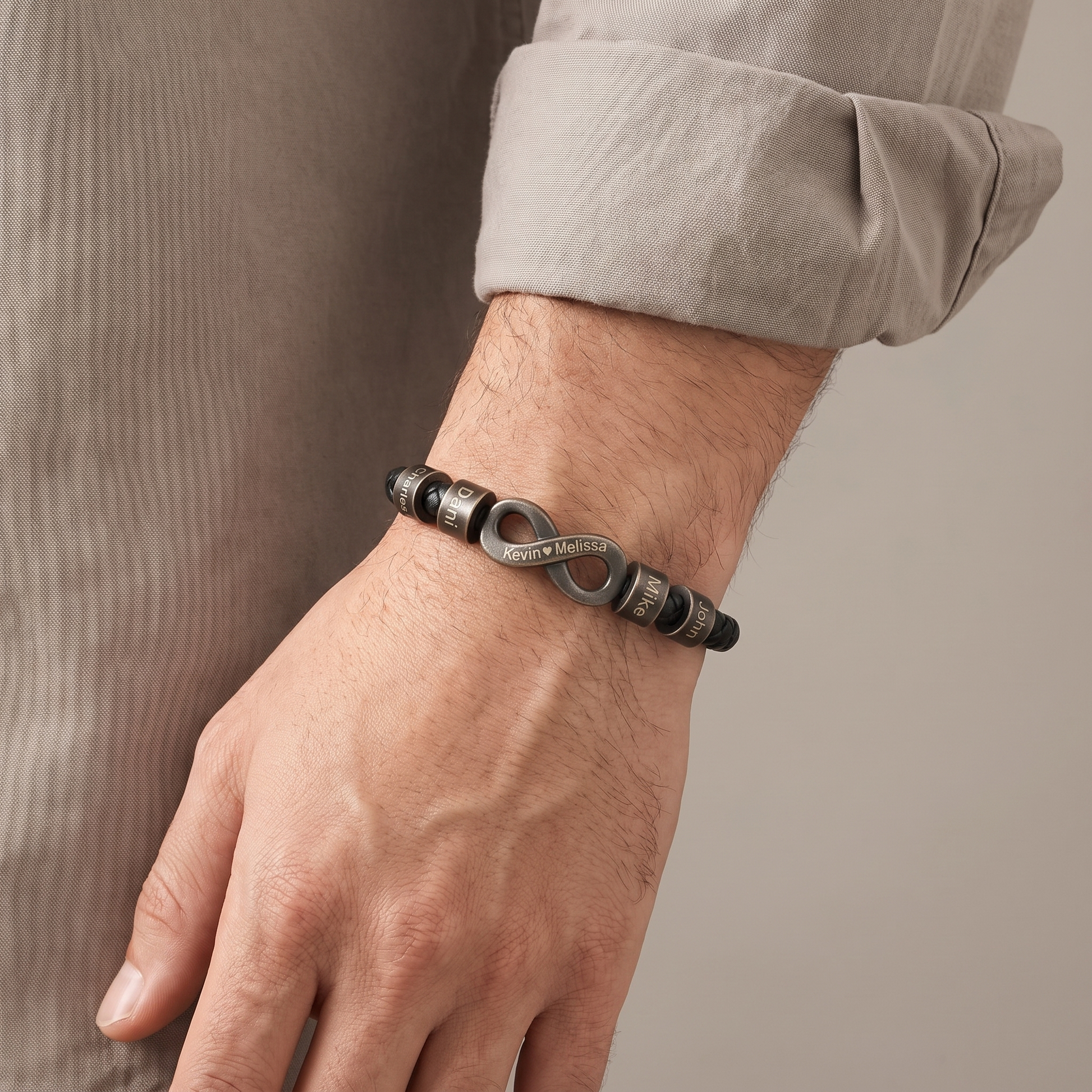Men's infinity name bracelet worn on wrist