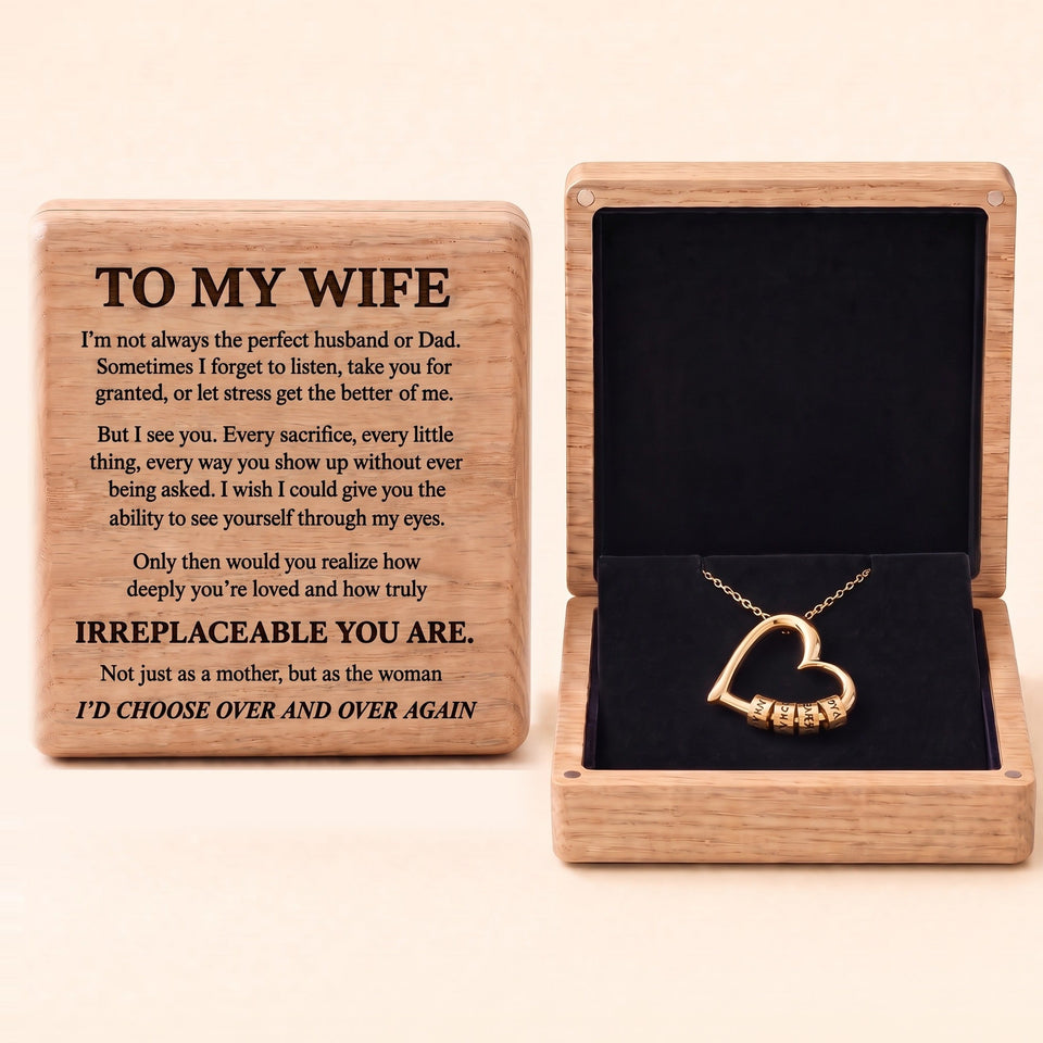 The Heart of Our Family gold heart necklace with engraved name beads in an oak box, To My Wife message engraved on the lid