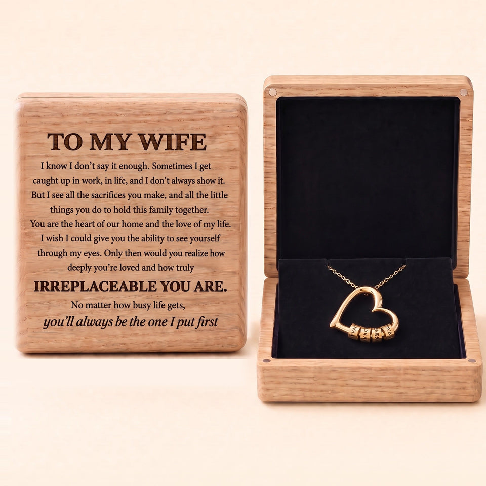 The Heart of Our Family gold heart necklace with engraved name beads in an oak box, To My Wife message engraved on the lid